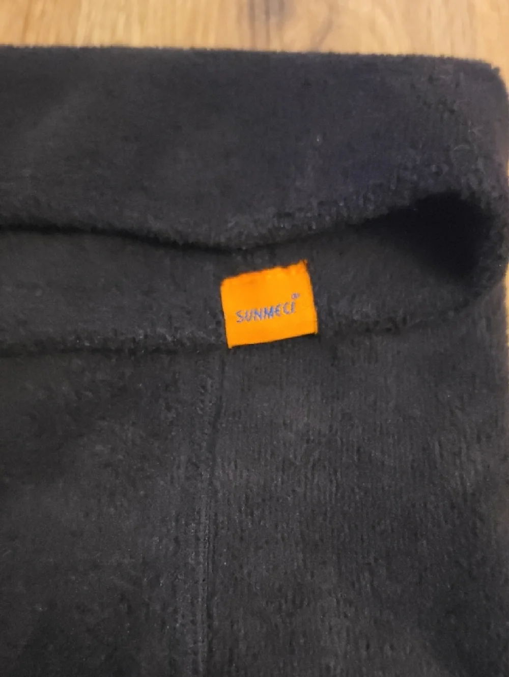 Black Sunmeci Neck Warmer with Orange Tag